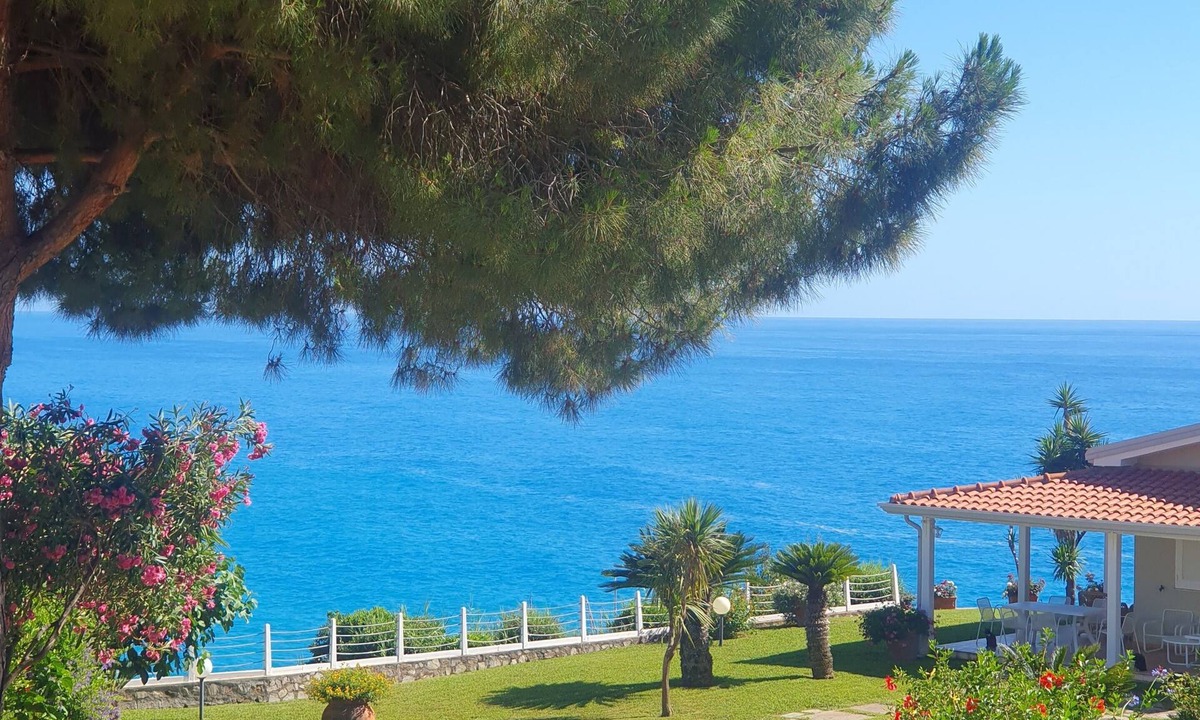 Bonifati Cottage | A beachfront cottage perched on a cliff, nestled in the lush greenery of the garden