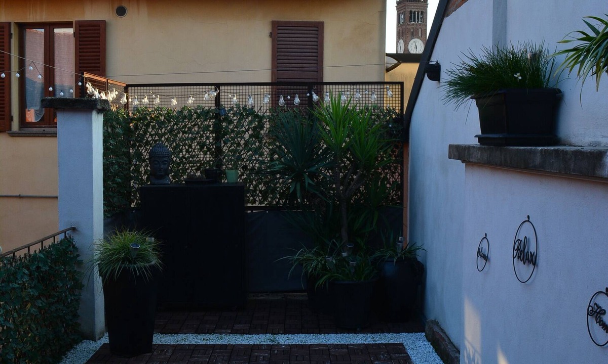 Treviglio Apartment | Relaxing apartment with terrace among the rooftops of an old building.