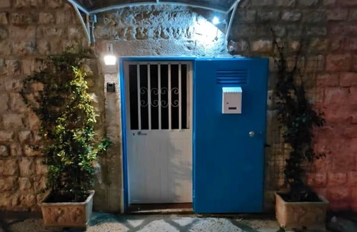 Molfetta House | Grotta Paradiso, a two-story stone cottage with a warm and cozy charm.
